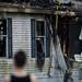 A firefighter extinguishes flames inside a house. Daniel Brenner I AnnArbor.com